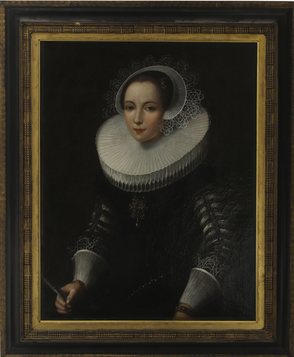 Portrait of a young lady, half- length, in a black dress with white lace ruff